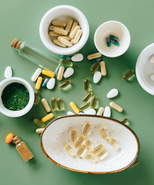 Various supplements in capsules and tablets on a green background. For a visual tip on respiratory health in high pollution.